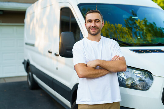 Portrait of confident man with arms crossed standing against van