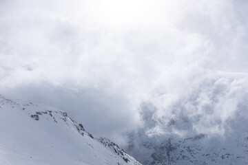 Clouds and sun over the mountain top