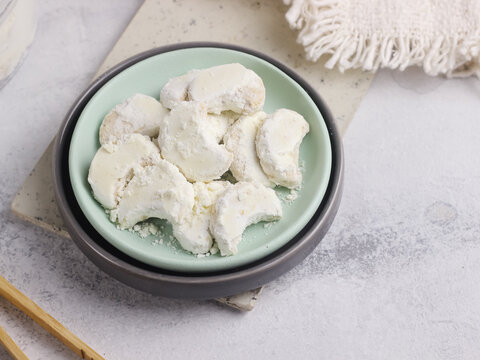 Kue Putri Salju Kacang Mede or "snow princess" white cookies with crescent shaped. Made from cashew, flour, sugar and butter coated with powdered sugar. Popular cookie to celebrate Eid al Fitr