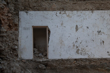 A damaged house with its door visible.