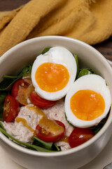 Light healthy salad with tuna, spinach, tomatoes and boiled egg