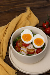 Light healthy salad with tuna, spinach, tomatoes and boiled egg