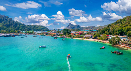 Island Phi Phi with longtail boat, turquoise clear water in Krabi Thailand. Amazing travel landscape photo in Thai © Parilov