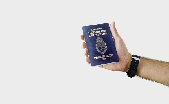 Man holding Argentina Passport in hand on white background with copy space - Argentine