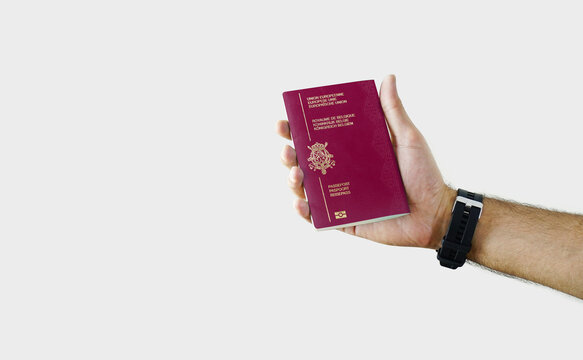 Man holding Belgium Passport in hand on white background with copy space - Belgian