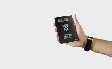 Man holding Croatia Passport in hand on white background with copy space - Croatian