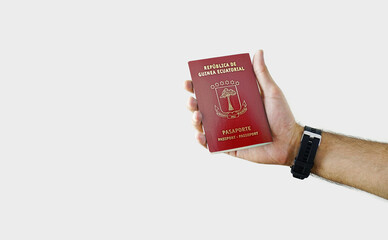Man holding EQUATORIAL GUINEA Passport in hand on white background with copy space - Equatorial...