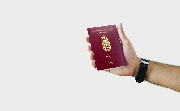 Man holding Denmark Passport in hand on white background with copy space - Danish
