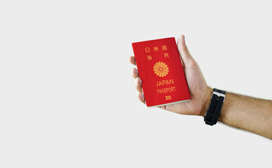 Man holding Japan Passport in hand on white background with copy space - Japanese