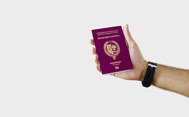 Man holding Senegal Passport in hand on white background with copy space - Senegalese