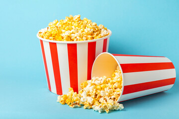 Popcorn box. Red and white striped buckets of popcorn on a blue background. Cinema and...