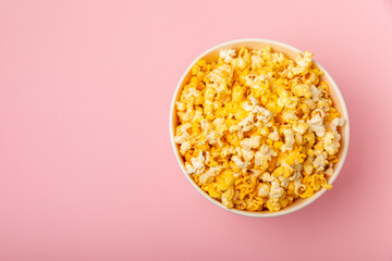 Tasty popcorn in color background. Cinema and entertainment concept. Movie night with...