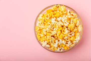 Tasty popcorn in color background. Cinema and entertainment concept. Movie night with...