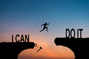 Man jumping on I can do it or I can't do it text over cliff on sunset background, Business concept...