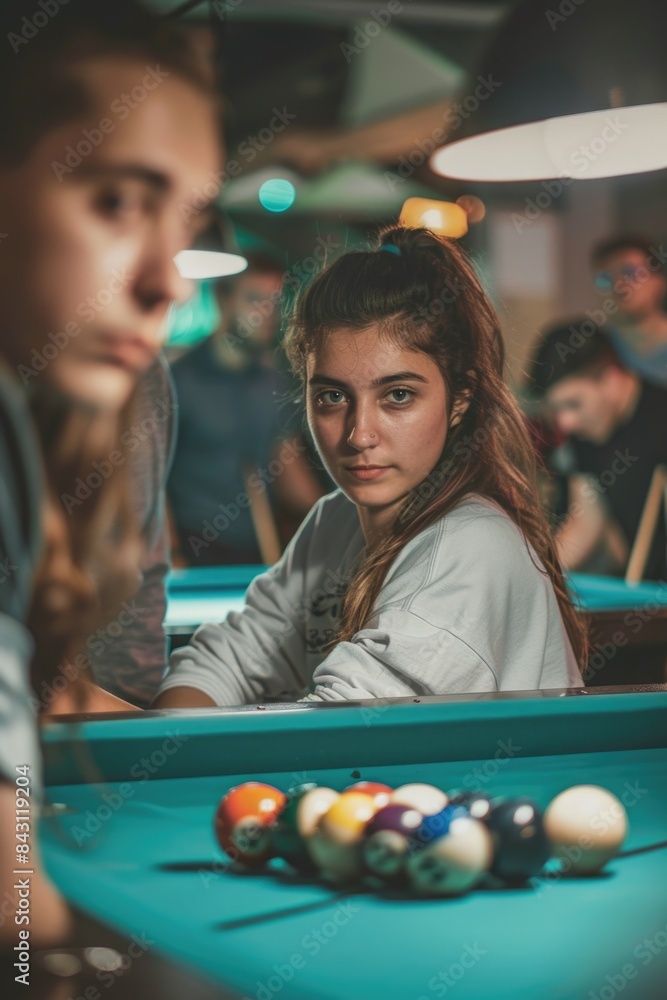 Poster a woman and a man sit next to each other at a pool table, engaged in a game