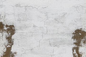 Concrete wall with rough cracked finishing for further plasterwork as a background