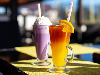 Bumble coffee, espresso with orange juice and blueberry milkshake on the table in the cafe