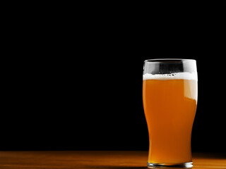 Beer glass on the table on a black background
