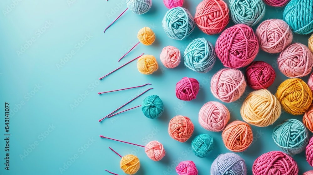 Wall mural   A collection of yarn balls resting on a table alongside crochet hooks - Wall murals
