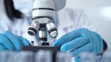 Scientist using microscope in laboratory