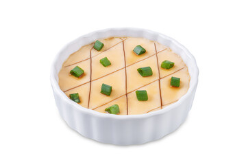 Asian steamed eggs in a bowl with soy sauce and scallions on a white isolated background