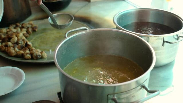 cooking food, taking broth from the pot, fa01