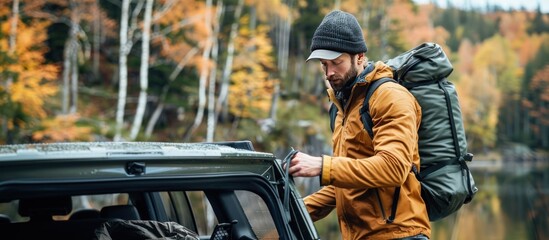 Sportsman getting bag out of trunk outdoors