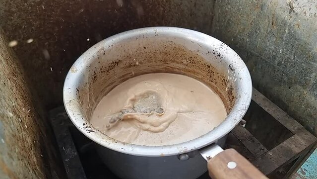 adding Jaggery in tea. adding Jaggery in pan. jaggery milk tea. Slow Motion Footage