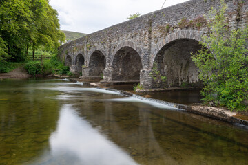 Fototapeta premium The river Barle flowing under Withypool bridge in Exmoor National Park