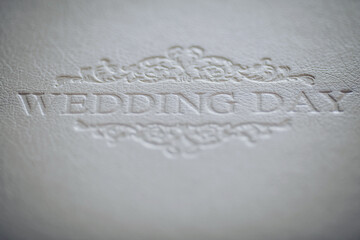 Photo book with embossing words wedding day on a cover of genuine leather. Services of a professional photographer and designer. texture of white leather.
