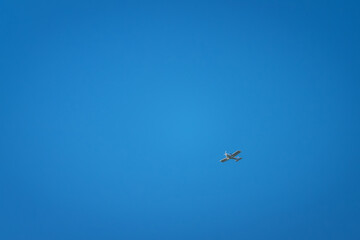 Small sightseeing plane in the blue sky.