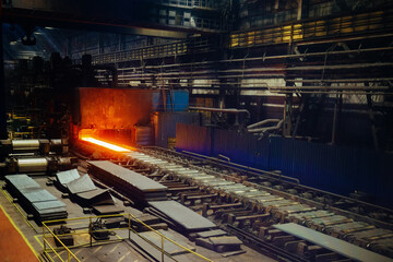 Rolled metal factory. Hot iron slab moving on conveyor of metal rolling mill © Mulderphoto