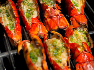 Grilled Lobster Tails with Garlic Lemon Butter Sauce Topped with Green Onions. Closeup Pictures During Preparation and Grilling. Summer Seafood Barbecue  