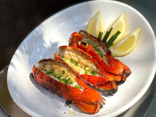 Grilled Lobster Tails with Garlic Lemon Butter Sauce Topped with Green Onions. Closeup Pictures During Preparation and Grilling. Summer Seafood Barbecue  