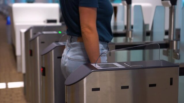 Access control systems in international airport. Validator. Checkpoint. Passenger Tapping Boarding Pass At Automated Self-boarding Gate Of An Airport.