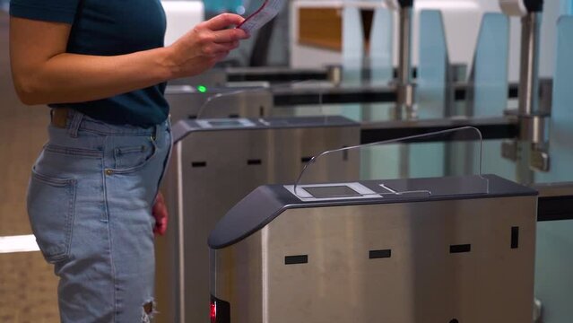 Access control systems in international airport. Validator. Checkpoint. Passenger Tapping Boarding Pass At Automated Self-boarding Gate Of An Airport.