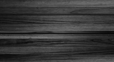 Texture of black and dark old wood. Charred and burnt old Board with knots. Wide burned board texture close-up, panoramic banner.