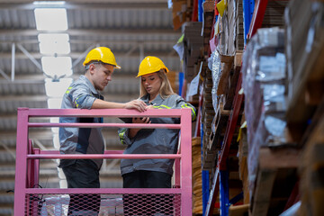 workers man and woman using a hydraulic scissor lift to check stock near the shelves warehouse. industry factory warehouse. Worker Screening Package In Warehouse.