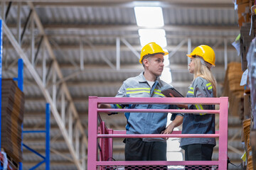 workers man and woman using a hydraulic scissor lift to check stock near the shelves warehouse. industry factory warehouse. Worker Screening Package In Warehouse.