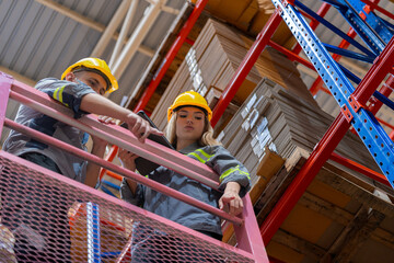 workers man and woman using a hydraulic scissor lift to check stock near the shelves warehouse. industry factory warehouse. Worker Screening Package In Warehouse.