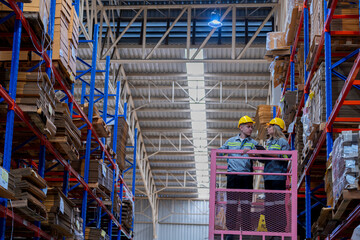 workers man and woman using a hydraulic scissor lift to check stock near the shelves warehouse. industry factory warehouse. Worker Screening Package In Warehouse.