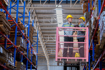 workers man and woman using a hydraulic scissor lift to check stock near the shelves warehouse. industry factory warehouse. Worker Screening Package In Warehouse.