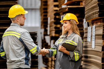 man and woman worker walking and checking stock for shipping. Female inspecting the store factory. Logistics employees holding folders at on site warehouse area for shipping transportation.