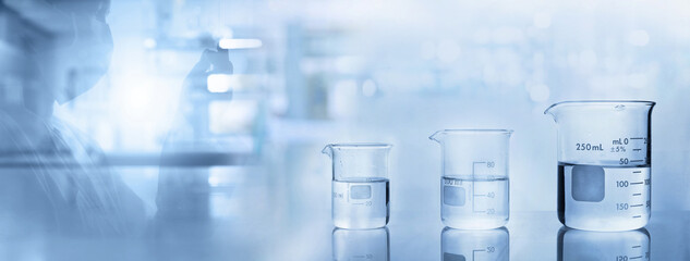 Scientist and beakers with water  in chemistry science lab banner background