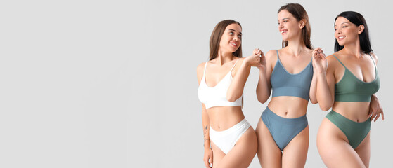 Beautiful women in underwear on light background