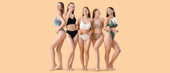 Many beautiful women in underwear on beige background