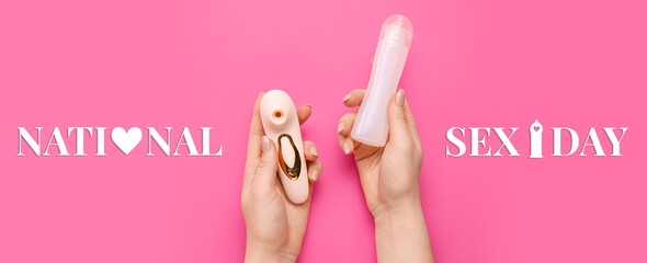 Hands holding satisfyer and bottle of lubricant on pink background. National Sex Day