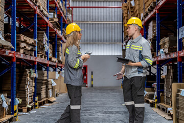 workers walking and checking stock items for shipping. male and female inspecting the store factory. Logistics employees holding folders at on site warehouse area for shipping transportation.