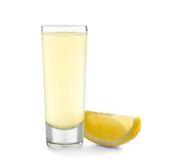 Shot of tasty Limoncello and lemon piece on white background