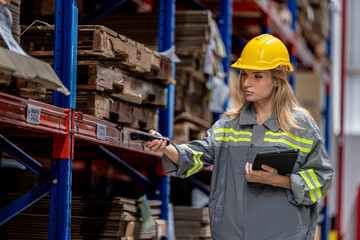 woman worker walking and checking stock items for shipping. Female inspecting the store factory....